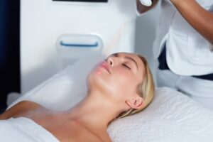 Attractive young woman getting local cryotherapy therapy